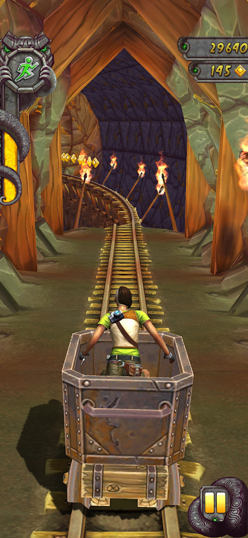Temple Run 2: riding a mining cart along train tracks in a cave.